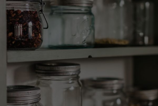 Glass mason jars on a shelf.