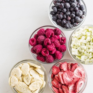 Four bowls of Augason Farms Freeze-Dried Fruit Variety Pail - 86 Fruit Servings and 113 Spiff-e-Whip Servings - (SHIPS IN 1-2 WEEKS), blueberries and raspberries.