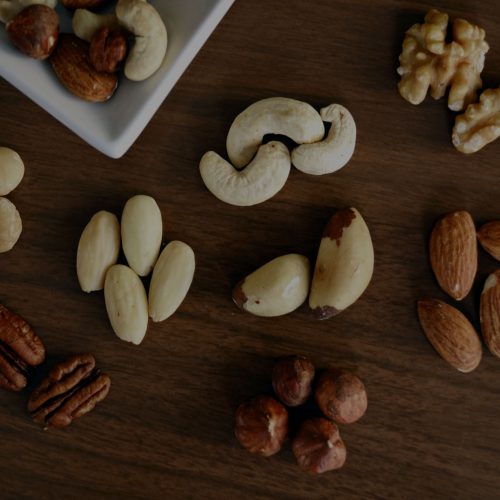 Nuts in a bowl on a wooden table.