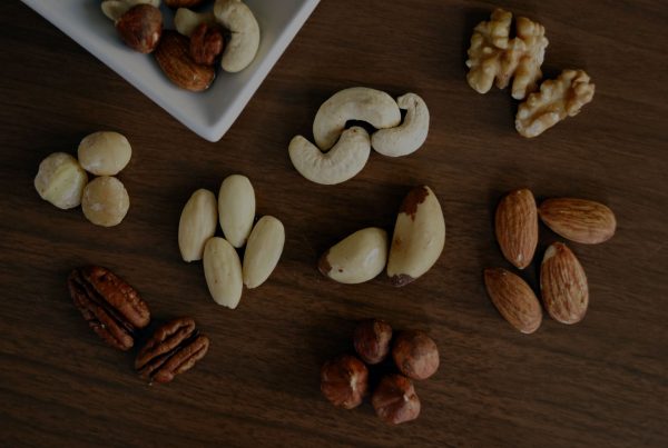Nuts in a bowl on a wooden table.