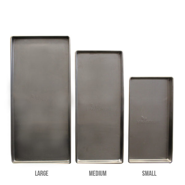 A set of four stainless steel baking pans in different sizes.