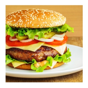 An Augason Farms Black Bean Burger 38 Serving #10 Can – (SHIPS IN 1-2 WEEKS) with lettuce, tomatoes and onions on a plate.