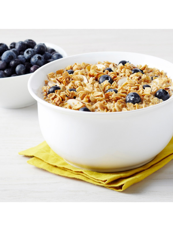 A bowl of Augason Farms Quick Rolled Oats 4 Gallon Pail 108 Servings - (SHIPS IN 1-2 WEEKS) with blueberries next to a napkin.