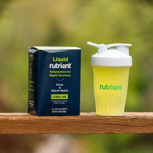 A bottle of Nutrient Survival Liquid Nutrient - Rehydration Drink 30 Serving - (SHIPS IN 2-4 WEEKS) sits next to a box.