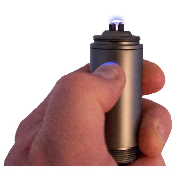 A person holding a ReadyWise (formerly Wise Food Storage) Cross Fire Dual-Arc Plasma Lighter (SHIPS IN 1-2 WEEKS) with a blue flame.