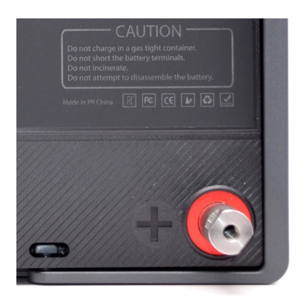 A Lion Energy Lion Safari UT 1300 Deep Cycle Battery with a red button on it.