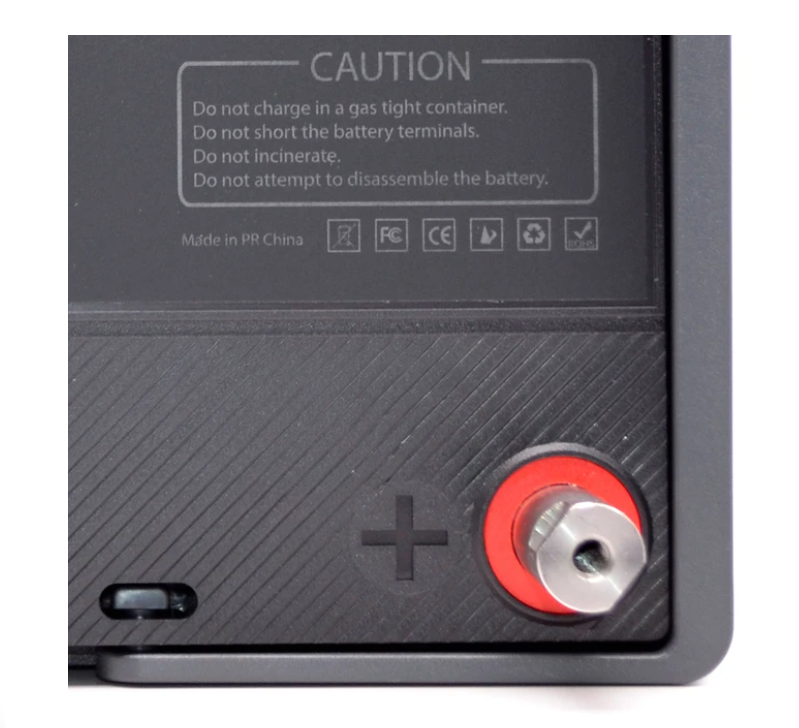 A Lion Energy Lion Safari UT 1300 Deep Cycle Battery with a red button on it.