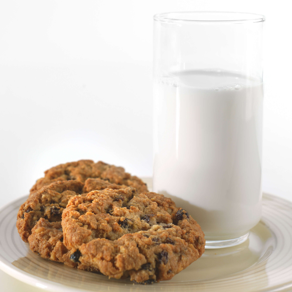 A Augason Farms 1-Week 1-Person Emergency Food Pail - (SHIPS IN 1-2 WEEKS) and cookies on a plate.