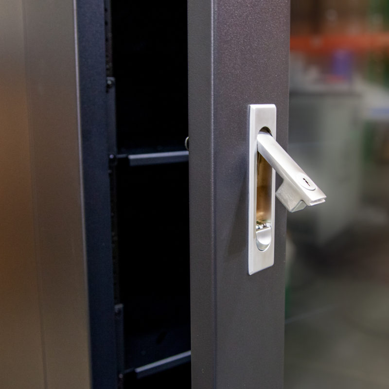 A close up of a metal door handle with Humless Power Tower.