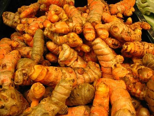 A pile of Enerhealth Botanicals TURMERIC ROOT EXTRACT - 4 Ounces - (SHIPS IN 1-2 WEEKS) on a table.