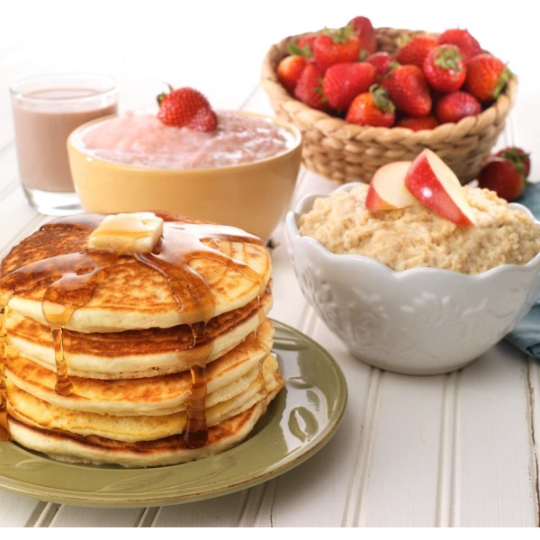A stack of Legacy Food Storage Emergency Food Ultimate Sample Pack - Survival Supply - 183 Large Servings - (SHIPS IN 1-2 WEEKS), strawberries, and yogurt on a wooden table.