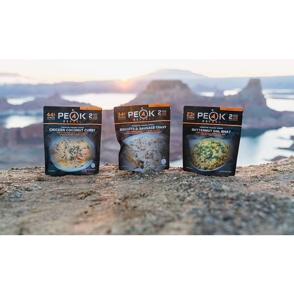 Three Peak Refuel Freeze-Dried Breakfast, Lunch, and Dinner Sampler Food Storage and Backpacking Food Kits sitting on top of a mountain.