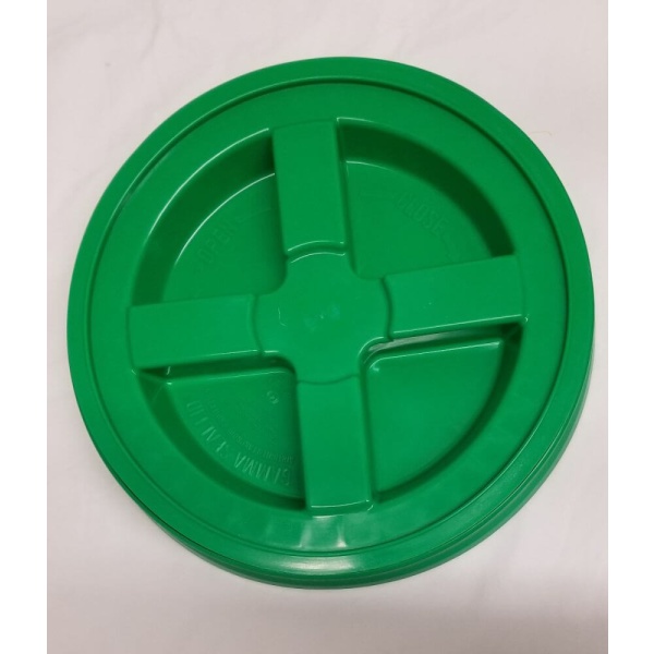 A green plastic plate with four holes for emergency food storage.