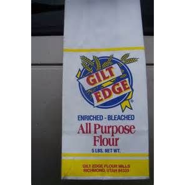 A 50 lbs bag of Rainy Day Foods Non-GMO All Purpose Flour on a car.