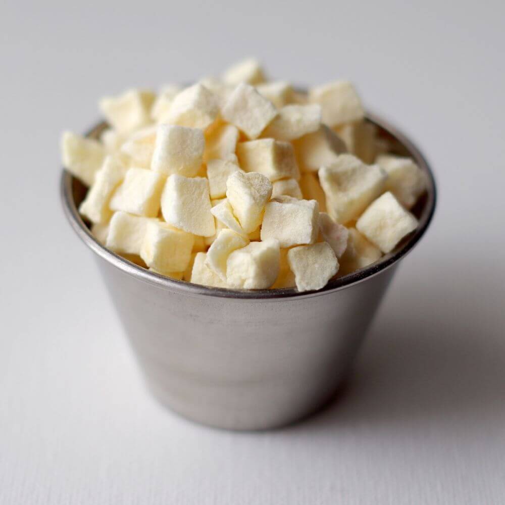 Cubes of white sugar in a silver bowl.