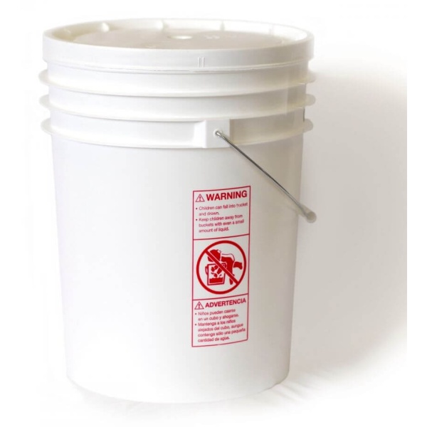A white bucket with a red label on it.