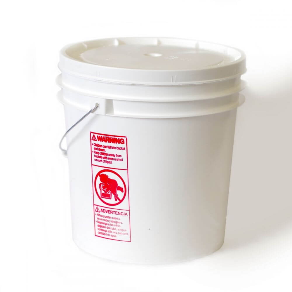 A white bucket with a red label on it.