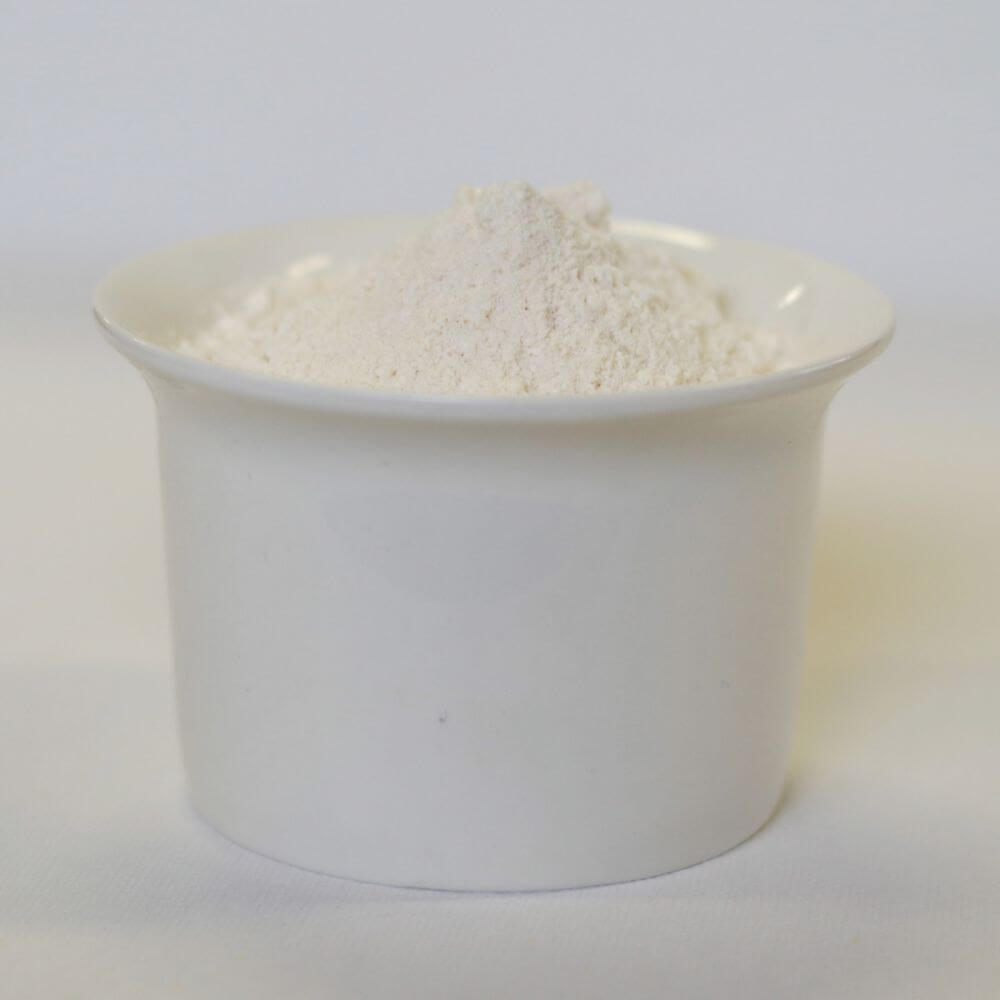 White powder in a bowl on a white surface.