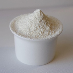 A white powder in a cup on a white surface.