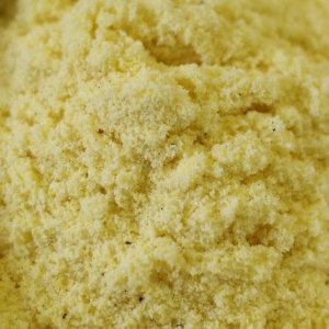 A close up of a yellow powder in a bowl.
