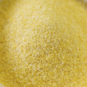 A yellow powder in a bowl on a white background.