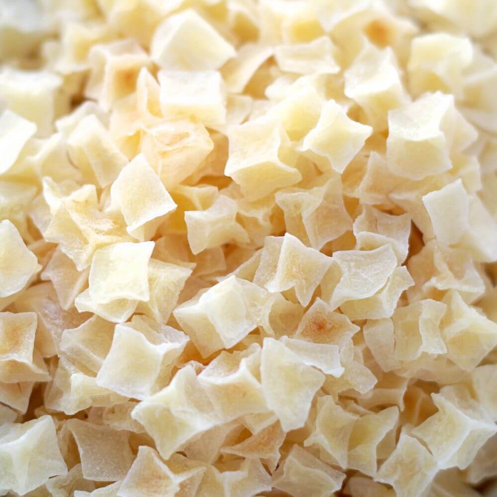 A close up of a pile of white shredded coconut.