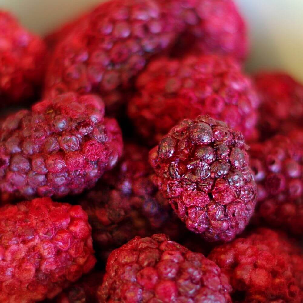 A bowl of raspberries in a white bowl.