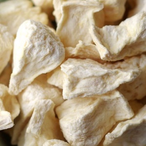 A close up of a pile of white pieces of fruit.