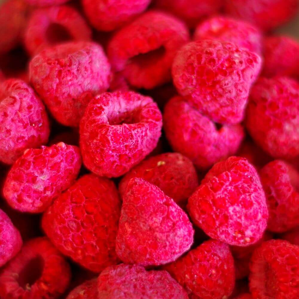A close up of raspberries in a bowl.