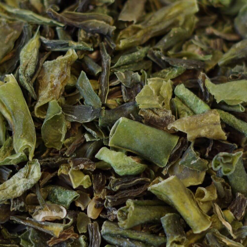 A close up of a pile of green tea leaves.