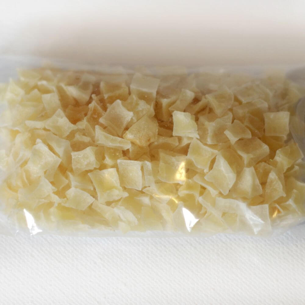 A bag of white sugar in a clear plastic bag.