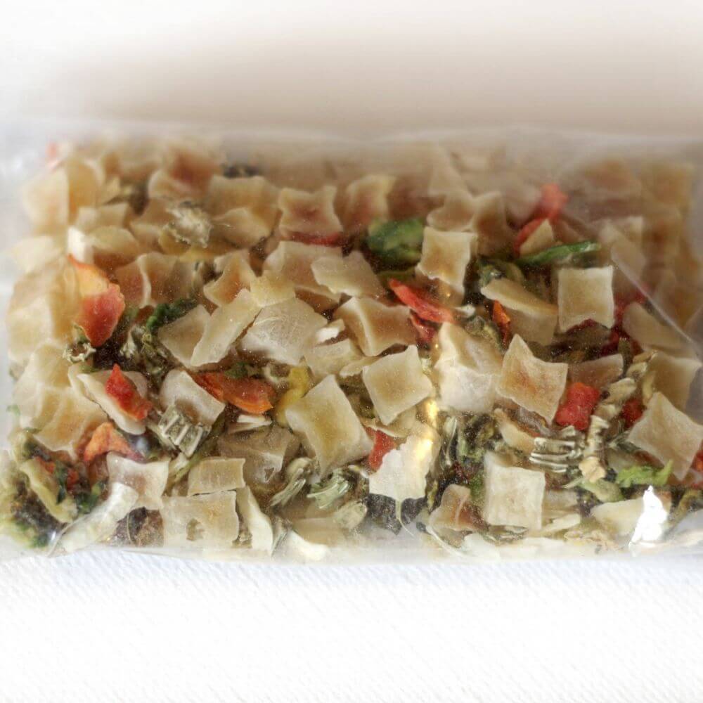 A bag of pasta and vegetables in a plastic bag.