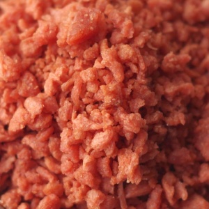 A close up of red meat in a bowl.