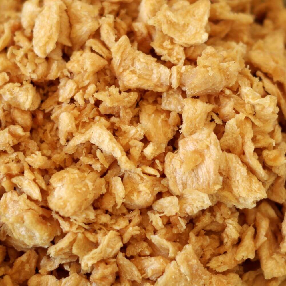 A close up of shredded chicken in a bowl.
