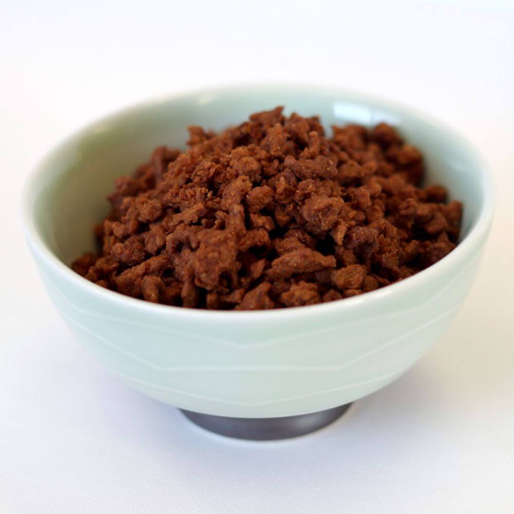A bowl of brown meat in a white bowl.