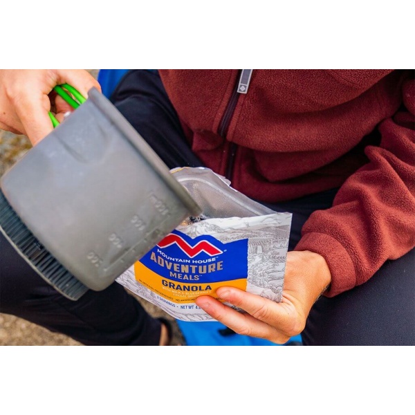 A person is holding a Mountain House Granola with Blueberries and Milk Mylar Pouch - 2 Servings - (SHIPS IN 1-2 WEEKS) in their hands.