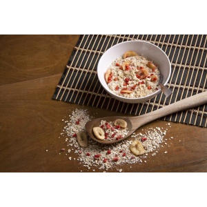 A bowl of NorthWest Strawberry Banana Oatmeal - Non-GMO, Gluten-Free, Kosher, and Vegan - 15 Servings - (SHIPS IN 1-3 WEEKS) is sitting on a wooden spoon.