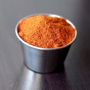Chile powder for emergency food storage in a small cup on a table.