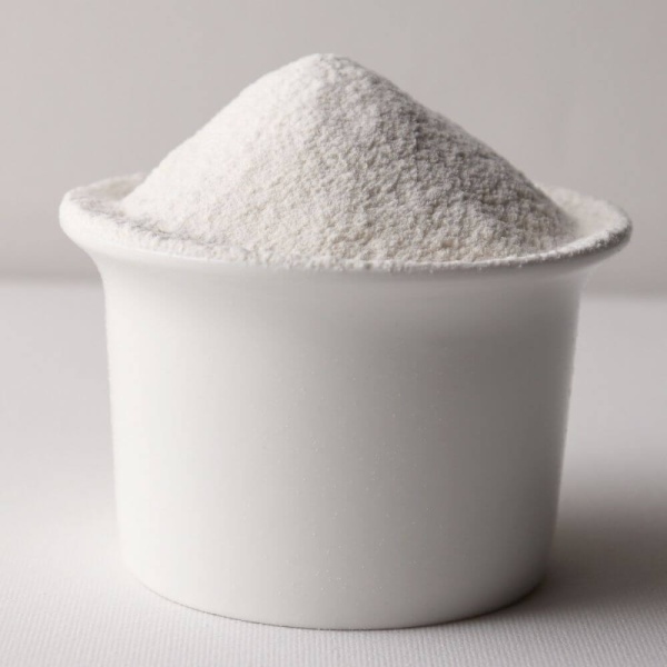 White powder in a white bowl on a white surface for emergency food storage.