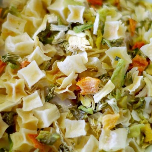 A bowl of pasta with vegetables, perfect for emergency food storage, in it.