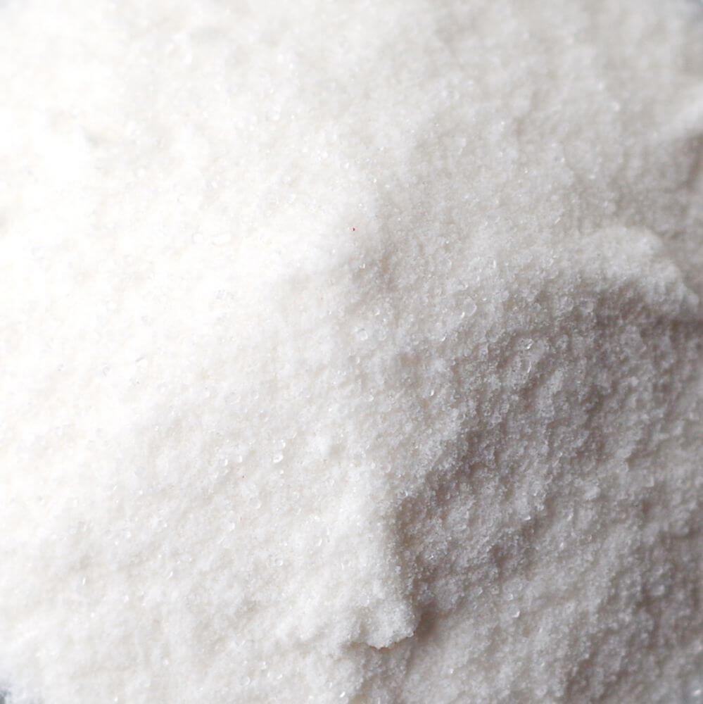 A close up of a pile of white sugar, perfect for emergency food storage.