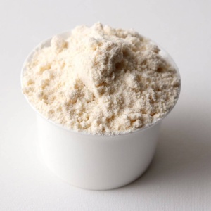 White powder in a cup on a white surface for emergency food storage.