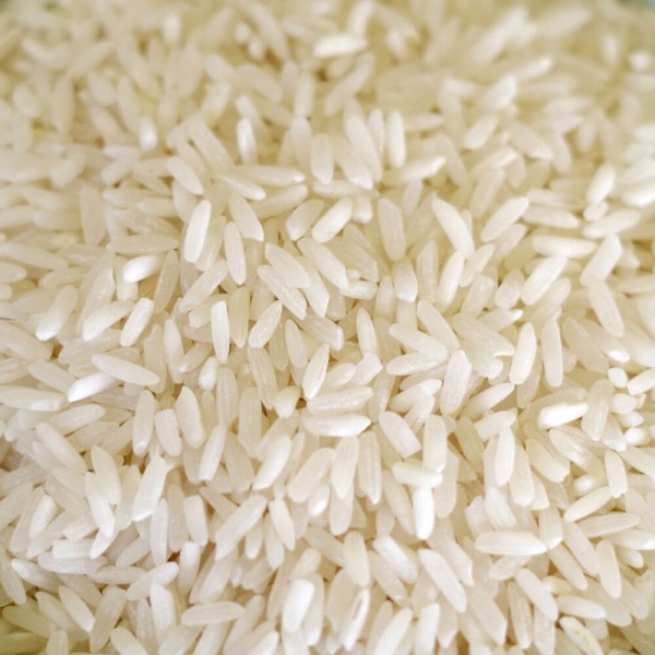 A close up of white rice, a popular choice for emergency food storage, in a bowl.