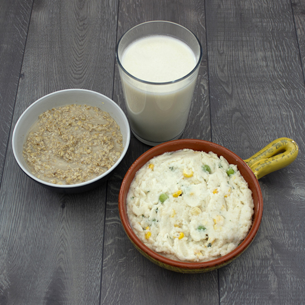 A bowl of Augason Farms Minuteman 24-Hour Meal Kit - 6 Pack - (SHIPS IN 1-2 WEEKS) and a glass of milk.