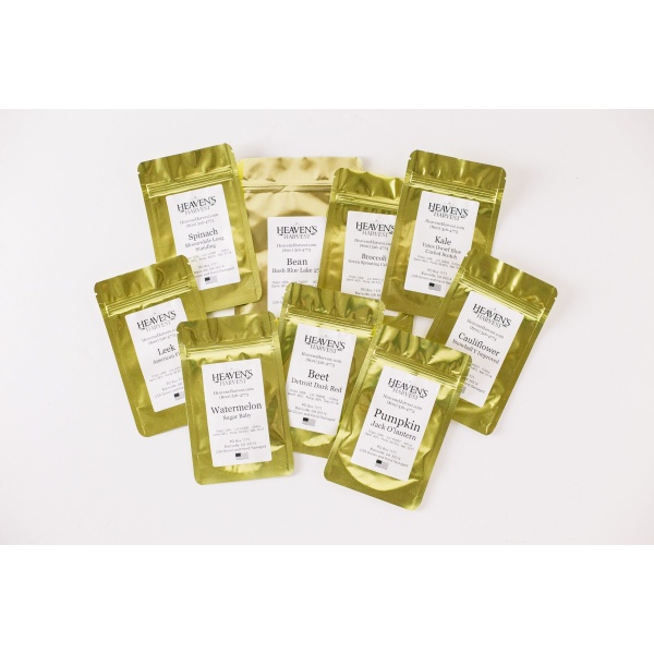 A group of gold packets on a white background from the Heaven's Harvest Heirloom Superfoods Seed Kit.