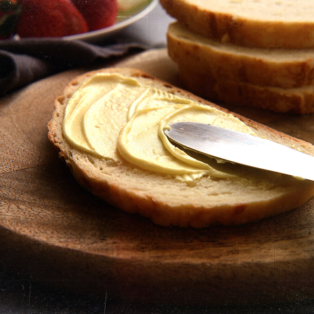 A slice of bread with nutrient-rich butter on it.