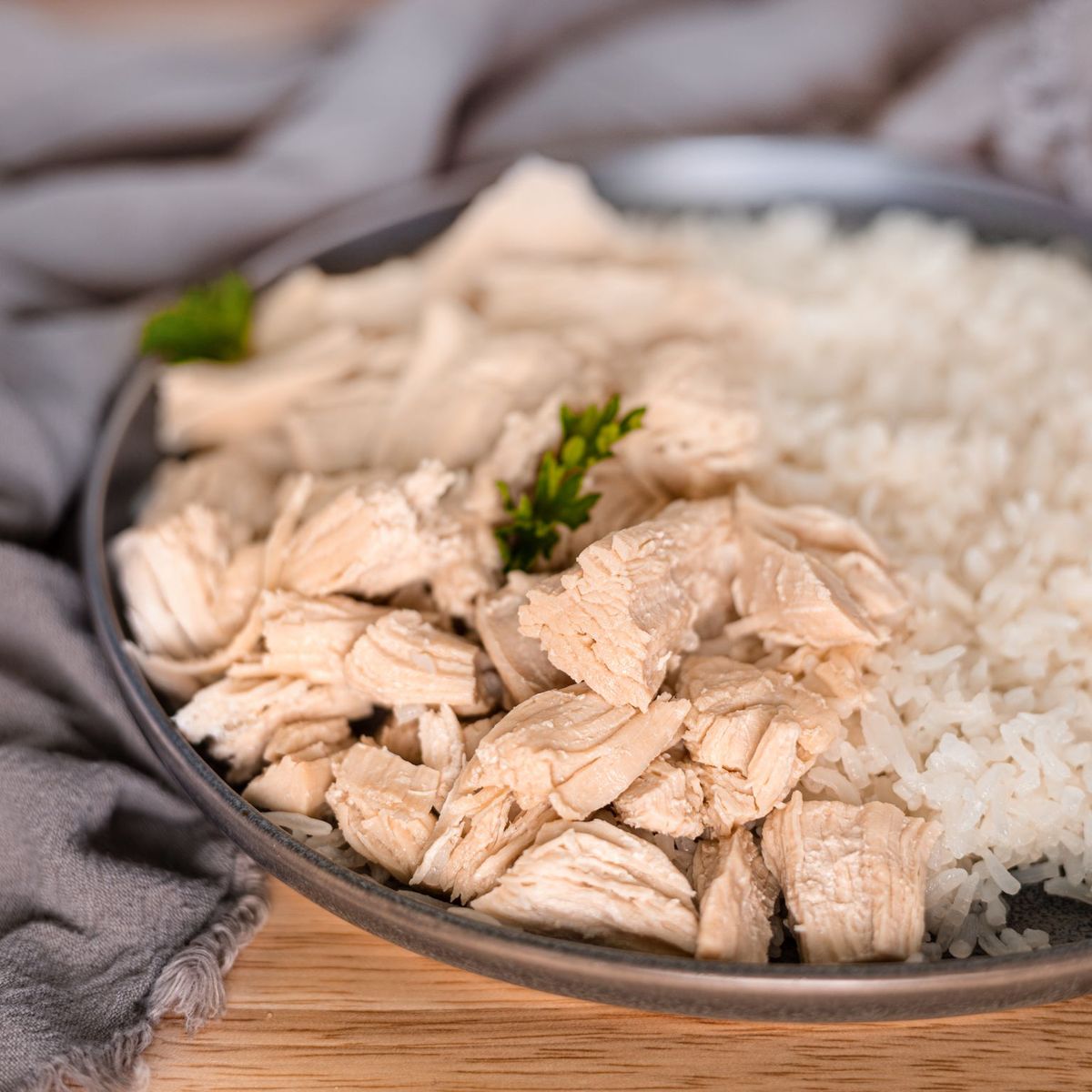A plate of rice and chicken, part of an emergency food storage, on a wooden table.
