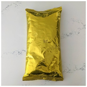 A gold foil bag on a white surface, CLEARANCE ITEM.