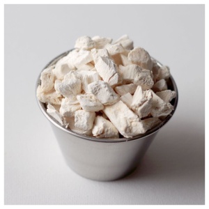 Freeze-dried tofu in a silver cup on a white surface.