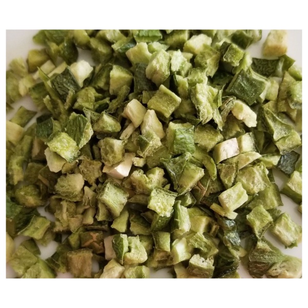A pile of chopped okra on a white plate with Rainy Day Foods Freeze-Dried Jalapeno Peppers.